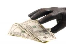 A gloved hand reaches out to grab cash