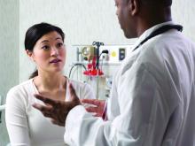 Female patient talking to male doctor