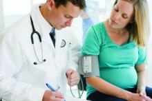Pregnant woman having her blood pressure taken