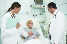 Health care providers tend to a pregnant patient in a hospital.
