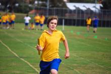 boy running a relay race