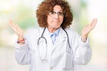 A doctor holds up her hands with a look of uncertainty