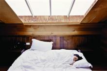 Skylight over a person sleeping in a bed