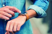 A person checks out the display on a smartwatch