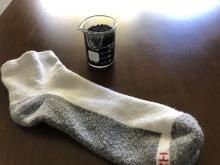 A sock and a beaker of glass beads used in mosquito study