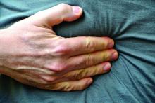 Hand on stomach indicating discomfort