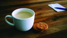 cup of tea and cookies sitting on a table