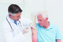 An older man receives a flu shot.