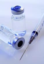 Vaccine vials and a syringe