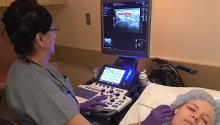 Magda Abdou, a senior vascular technologist at Brigham and Women’s Hospital vascular diagnostic lab, performs an ultrasound evaluation of the temporal artery.