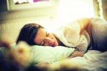 Woman with pain lying on bed