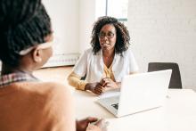 A female physician talks to a patient