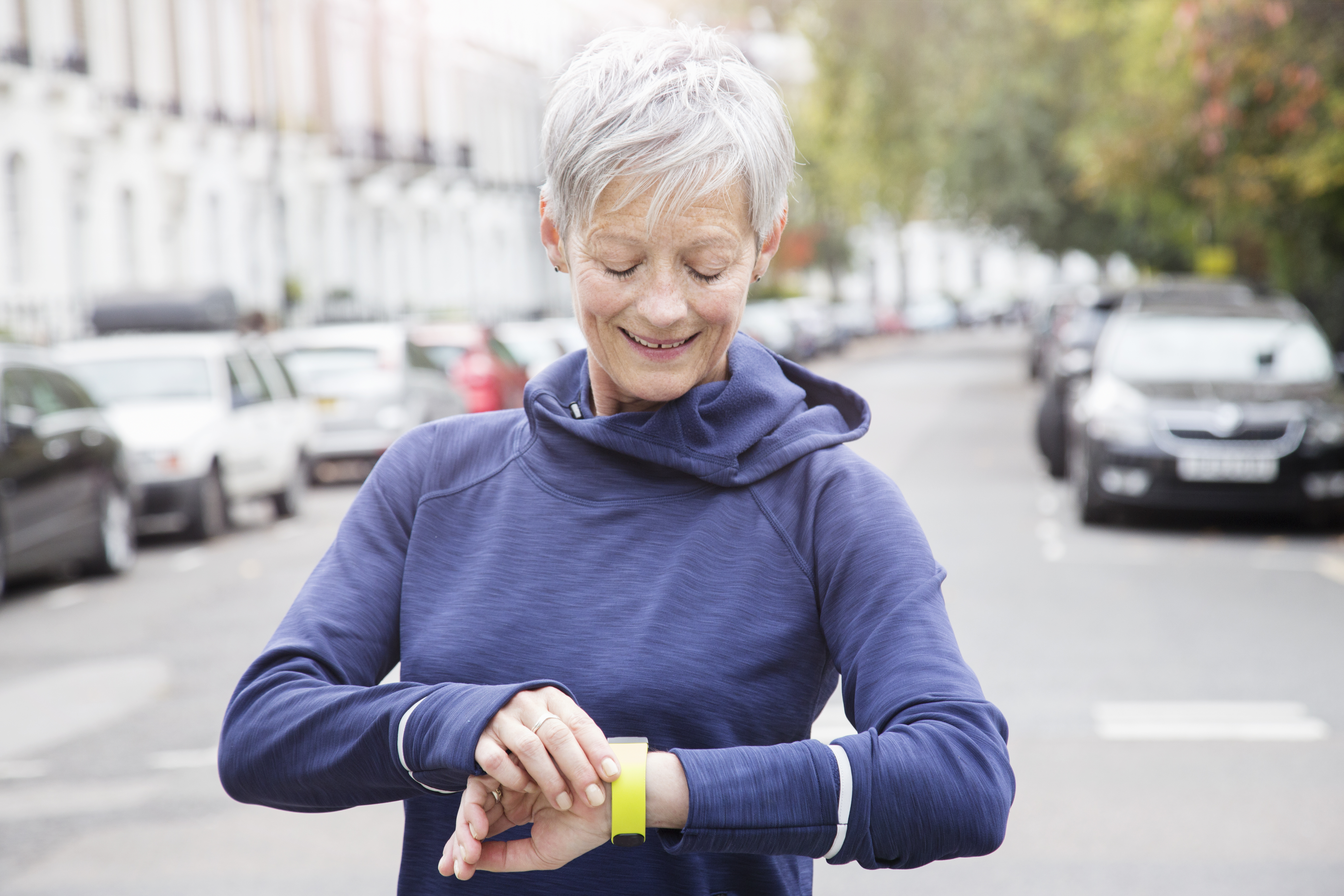image of a woman checking her wearable wrist monitor